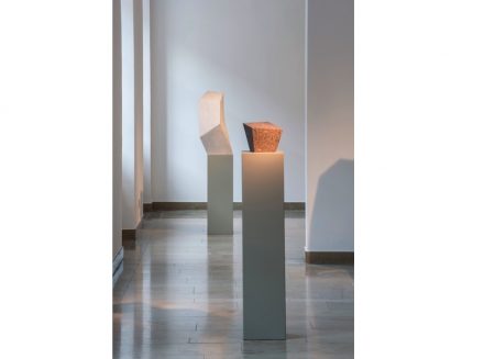 Blick in die Ausstellung. Im Vordergrund die Skulptur „Ohne Titel (Christoph Voll zum Gedenken)“, roter schwedischer Granit aus dem Jahr 2002, im Hintergrund Ohne Titel, 1988-90, Marmor.