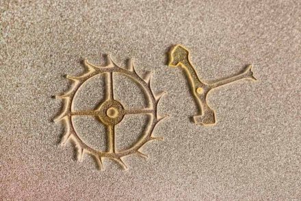 Künstlerische Darstellung eines Hemmungsrads (links) aus Kunstdiamant mit einem Durchmesser von 3 Millimetern. Rechts der Anker, der immer wieder in das Rad eingreift und es blockiert. Quelle: EPFL