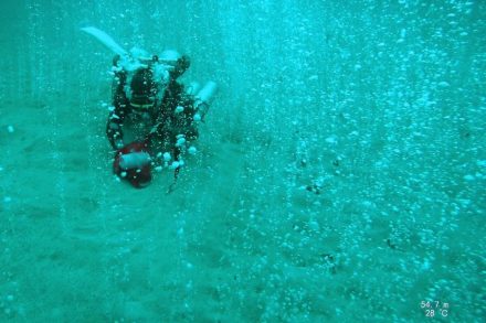 A researcher collects gas samples at Soda Springs in the Philippines. Photo: University of Texas at Austin Jackson School of Geosciences