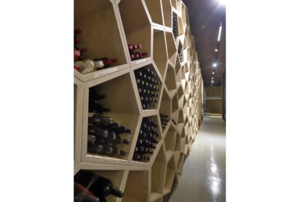 In the Zyme’ Winery close to Verona, in the so-called archive, a storage area for very special wines was conceived as an entire wall of pentagonal shelves in Giallo Dorato.