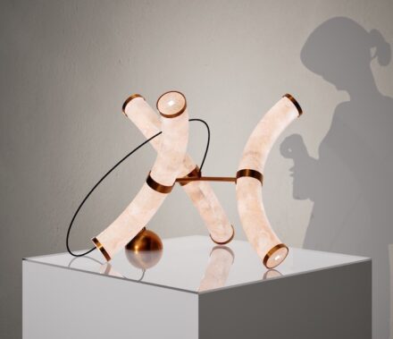 LuxOnyx: Designer/S: Andrea Sgherza, Professor Giuseppe Fallacara. ACADEMIC Institution: Polytechnic of Bari. Affiliated companY: Stoneform. Material used: Onyx. LuxOnyx is a luxury modular lighting system made of curved onyx tubes and metal connectors. Inspired by geometric tessellation, it forms intricate, repeatable designs. Configurable as lamps or chandeliers, it combines LED lighting with onyx's natural translucency, creating a meditative atmosphere. LuxOnyx merges premium materials with meticulous craftsmanship.