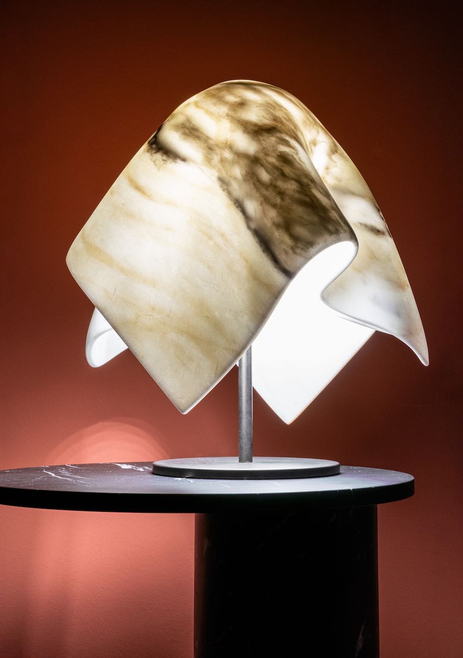Budri and the designer Bruno Tarabella: a table lamp with a marble shade where the light illuminates the stone, while the veins dim the brightness