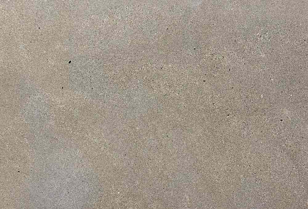 Sandstone RUSTIC, a fine-grained calcarenite with grey-brown tones, evoking a sense of power and tradition, quarried by Rubio Stone in Northern Spain